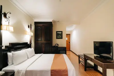 a bedroom with a large bed and a television at Hotel De' La Ferns, Cameron Highlands in Cameron Highlands