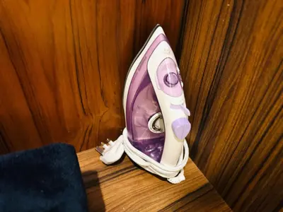 a purple and white hair dryer sitting on a table at Mansion One by Hejmo Suites in George Town