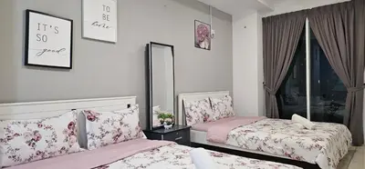 a bedroom with two beds and a mirror at Mansion One by Hejmo Suites in George Town