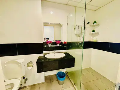 a bathroom with a toilet and a sink and a shower at Mansion One by Hejmo Suites in George Town