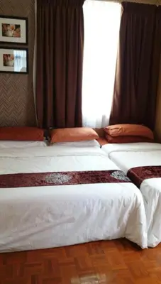 three beds in a room with a window at Partial Seaview with Wifi, Batu Ferringhi in Batu Ferringhi