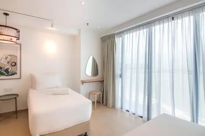 a bedroom with a bed and a large window at Sunrise Gurney in George Town