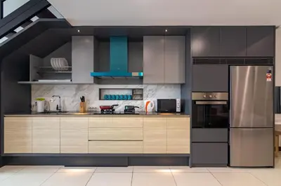 a kitchen with wooden cabinets and a stainless steel refrigerator at Sunrise Gurney in George Town