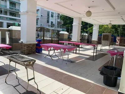 a group of pink tables on a patio at Woon Homestay in Balik Pulau