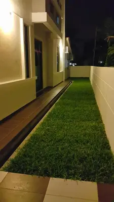 a room with grass on the side of a building at Woon Homestay in Balik Pulau