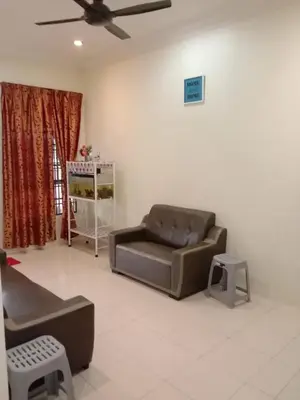 a living room with a couch and a chair at ARUWDA Homestay in Ipoh