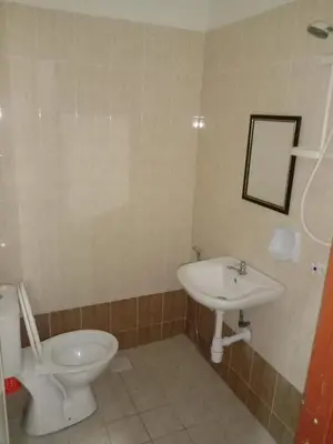 a bathroom with a toilet and a sink at ARUWDA Homestay in Ipoh