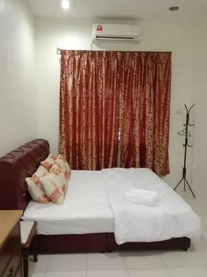 a bedroom with a bed and a window with avertisement at ARUWDA Homestay in Ipoh
