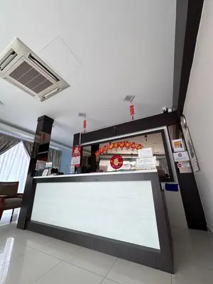 a food counter in a restaurant with a white sign at G Star Hotel in Pantai Remis