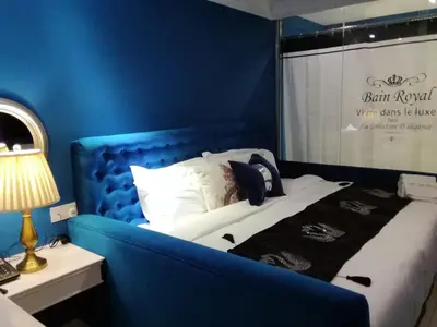 a blue bedroom with a bed with a blue wall at 1 Day Car Hotel Station 18 in Ipoh