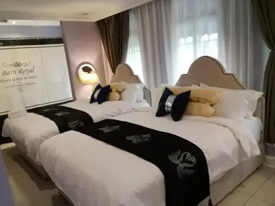 a group of three beds in a hotel room at 1 Day Car Hotel Station 18 in Ipoh