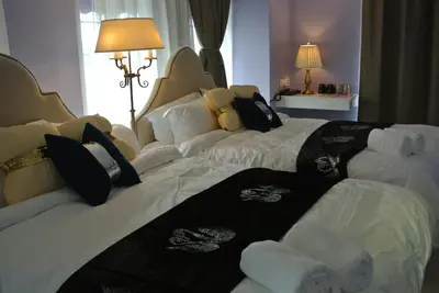 two beds in a hotel room with towels on them at 1 Day Car Hotel Station 18 in Ipoh