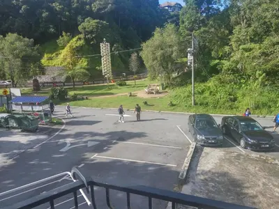 a parking lot with cars parked in a park at H2O Apartment in Cameron Highlands