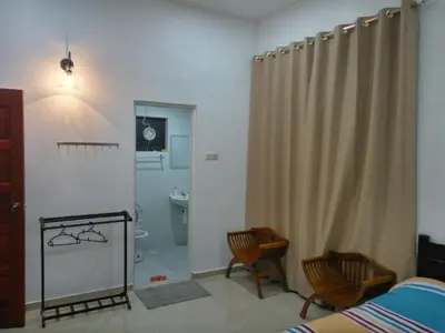 a bedroom with a shower curtain and a bathroom at H2O Apartment in Cameron Highlands