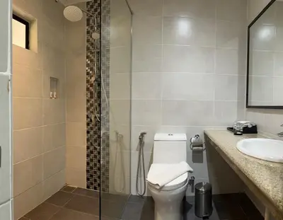 a bathroom with a toilet and a shower and a sink at Pangkor Sandy Beach Resort in Pangkor