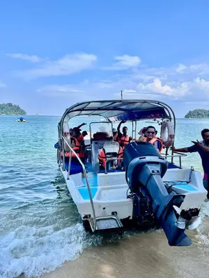 a group of people on a boat in the water at Pangkor Sandy Beach Resort in Pangkor