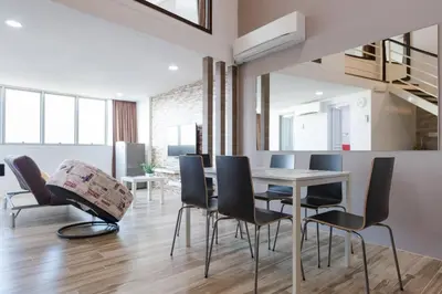 a dining room with a table and chairs at 3-Bed Executive Suite, RumahKu @CEO in Bayan Lepas