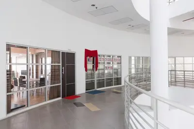 an office lobby with a staircase and glass doors at 3-Bed Executive Suite, RumahKu @CEO in Bayan Lepas