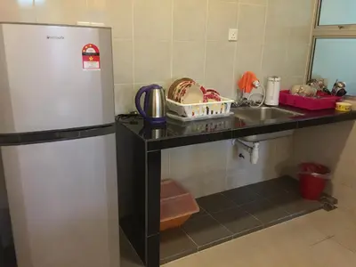 a kitchen with a refrigerator and a sink at Cameron DreamWorld Apartment @ Golden Hill in Cameron Highlands