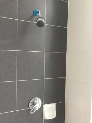 a shower with a shower head in a bathroom at Cameron DreamWorld Apartment @ Golden Hill in Cameron Highlands