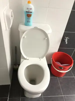 a white toilet with a bottle of cleaning fluid on top of it at Cameron DreamWorld Apartment @ Golden Hill in Cameron Highlands