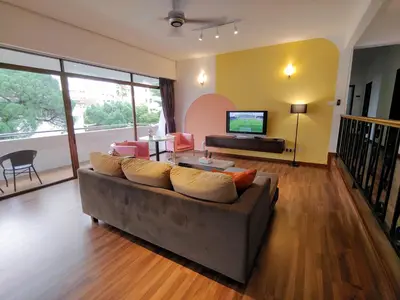 a living room with a couch and a television at GurneyVille in George Town