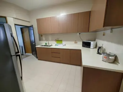 a kitchen with a refrigerator and a counter top at GurneyVille in George Town