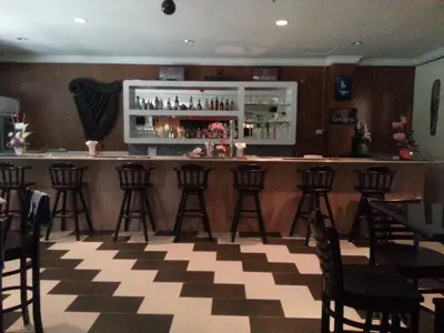 a bar with bar stools and a counter in a restaurant at Lumut Valley Resort Condominium in Lumut