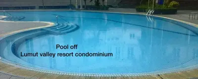 a large swimming pool with blue water at Lumut Valley Resort Condominium in Lumut