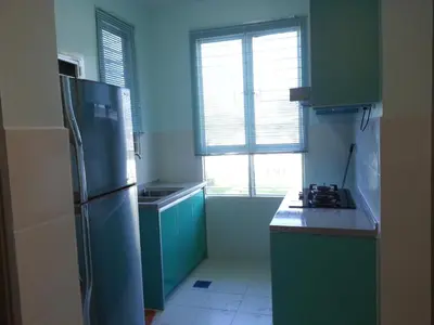 a kitchen with green cabinets and a refrigerator at VVIP Homestay Villa Proton City in Tanjung Malim