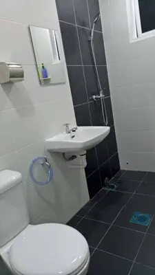 a bathroom with a white toilet and a sink at Pangkor Holiday Home in Pangkor