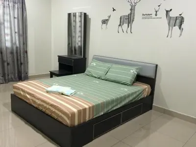 a bedroom with a bed in a room with animals on the wall at Sri Manjung Ma Maison Homestay in Lumut