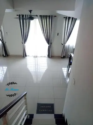 a living room with a large window and a tile floor at Sri Manjung Ma Maison Homestay in Lumut