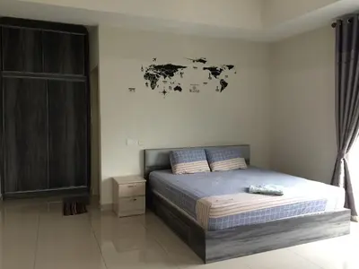 a bedroom with a bed and a map on the wall at Sri Manjung Ma Maison Homestay in Lumut