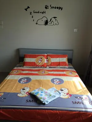a bed with a hello kitty comforter and pillows on it at Sri Manjung Ma Maison Homestay in Lumut