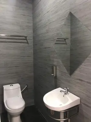 a bathroom with a white toilet and a sink at Baling Mountain Garden Village in Baling
