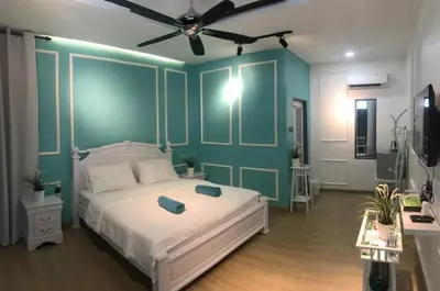 a bedroom with a bed and a ceiling fan at Baling Mountain Garden Village in Baling