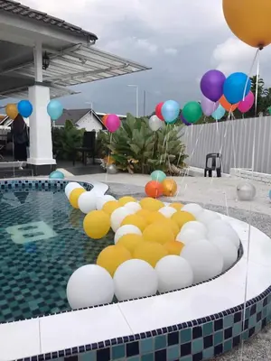 a pool with a bunch of balloons in the water at Baling Mountain Garden Village in Baling