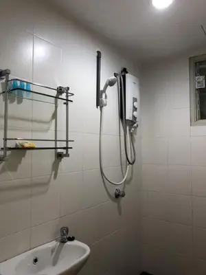a shower in a bathroom with a sink at Muslim Homestay Apartment in George Town