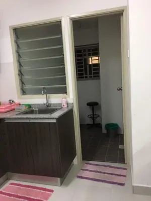 a bathroom with a sink and a mirror at Muslim Homestay Apartment in George Town