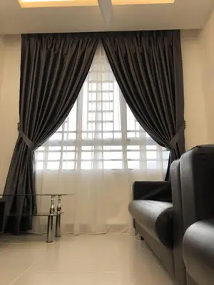 a living room with a couch and a large window at Muslim Homestay Apartment in George Town