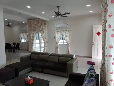 a living room with a couch and a table at Sitiawan Homestay Entire Semi D house in Sitiawan