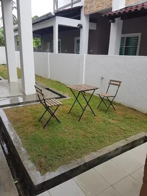 two chairs and a picnic table in a yard at Sitiawan Homestay Entire Semi D house in Sitiawan