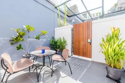 a room with a table and chairs and plants at Tien Hotel Georgetown in George Town