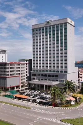 a large white building with cars parked in a parking lot at Sunway Hotel Seberang Jaya in Perai