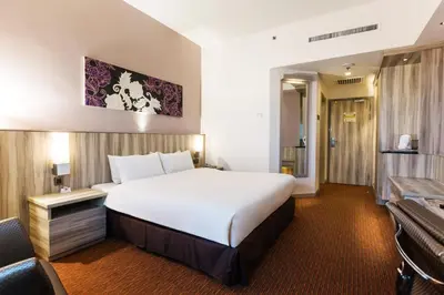 a hotel room with a large white bed in it at Sunway Hotel Seberang Jaya in Perai