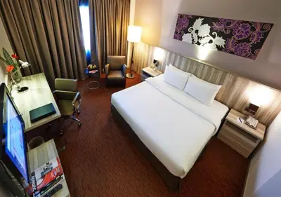 a hotel room with a large bed and a television at Sunway Hotel Seberang Jaya in Perai