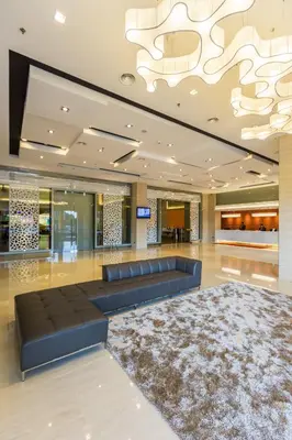 a lobby with a couch and a large chandelier at Sunway Hotel Seberang Jaya in Perai