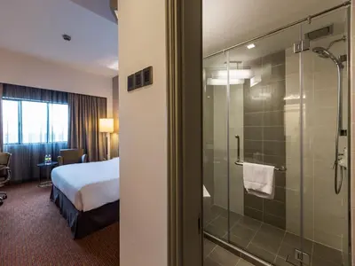 a hotel room with a bed and a glass shower at Sunway Hotel Seberang Jaya in Perai