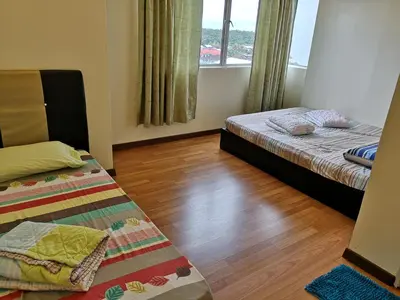 a bedroom with two beds and a wooden floor at \u672c\u5e97\u597d\u6c11\u5bbf in Sekincan